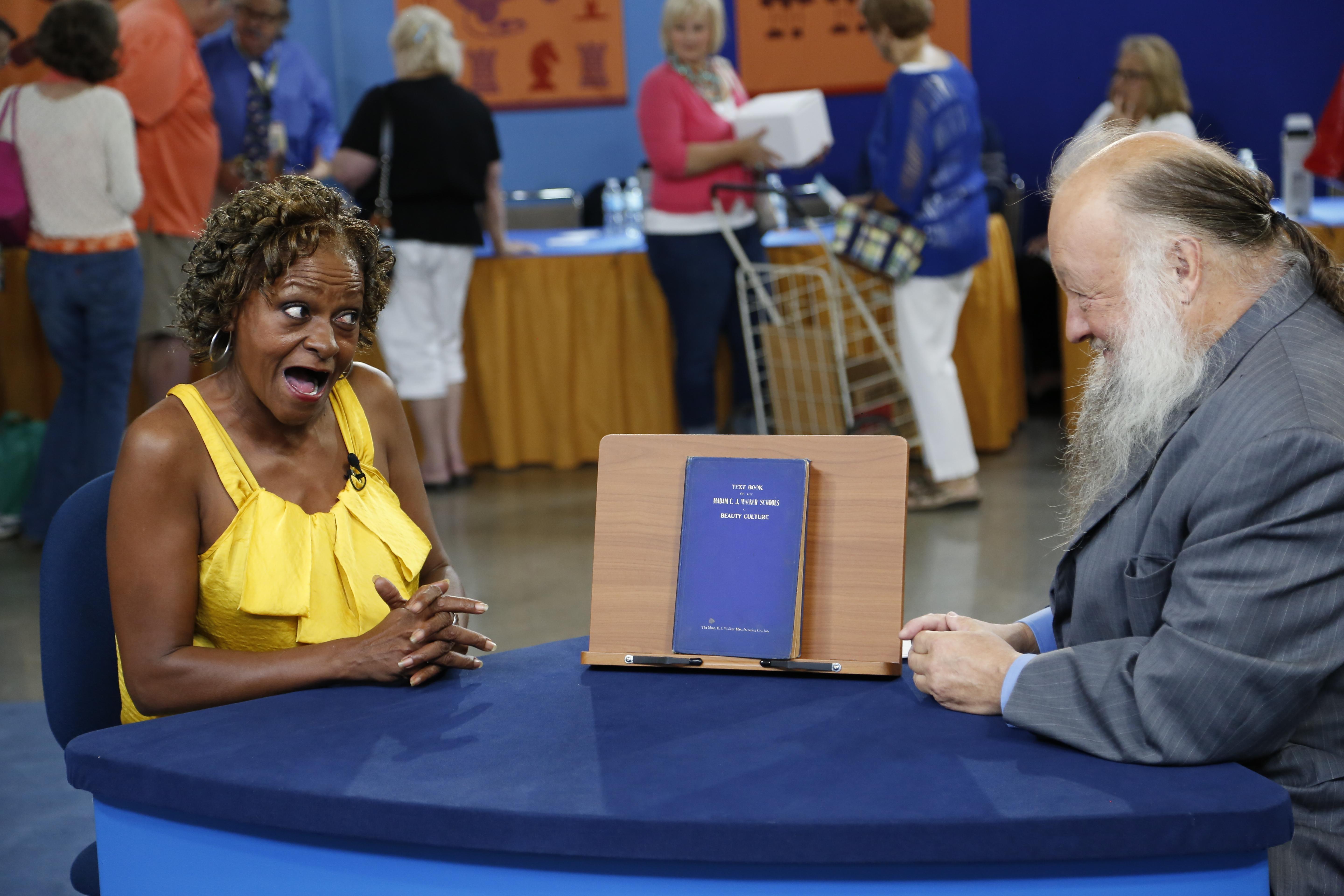 A woman looking surprised on Antiques Roadshow