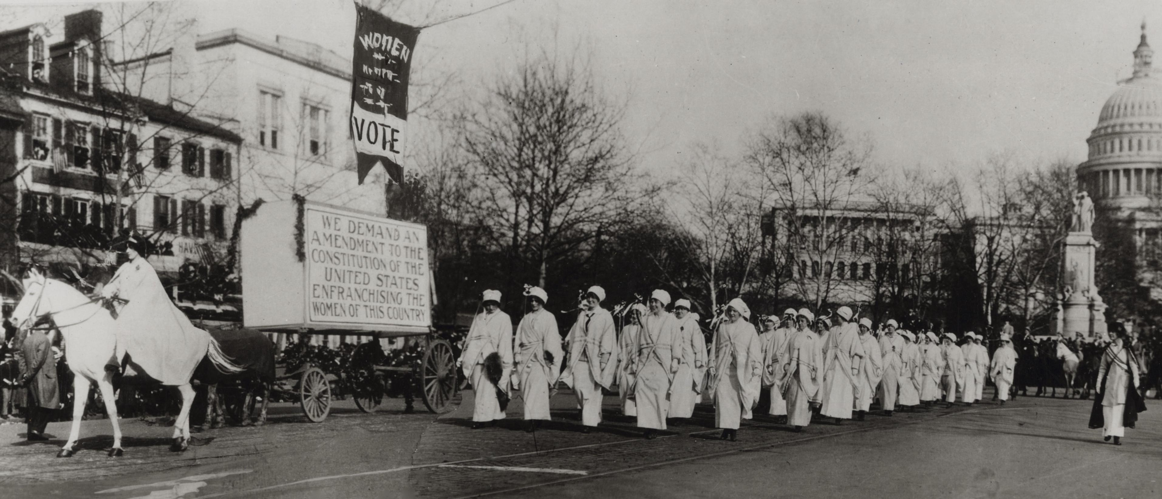 A historic image of women marching for the vote