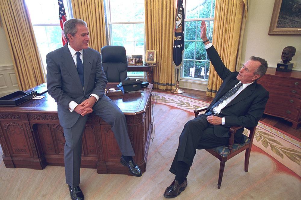 George W. Bush and George HW Bush in the Oval Office