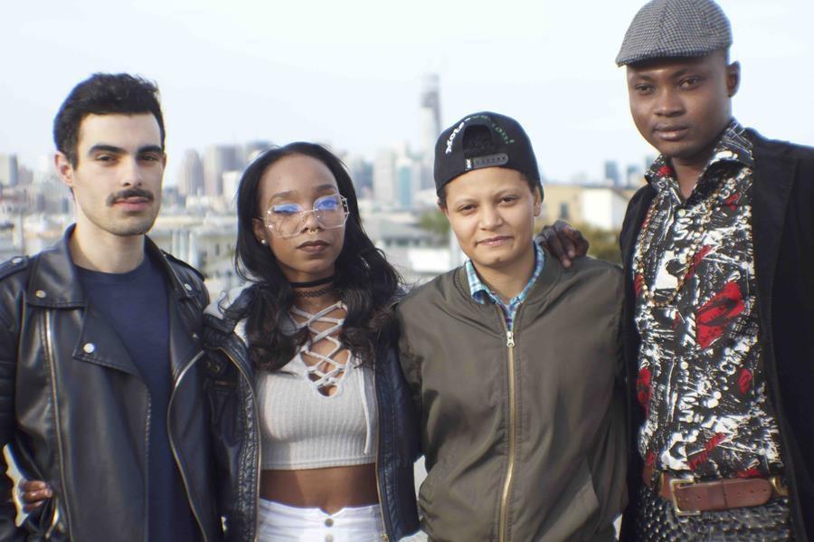 Four people smiling at camera