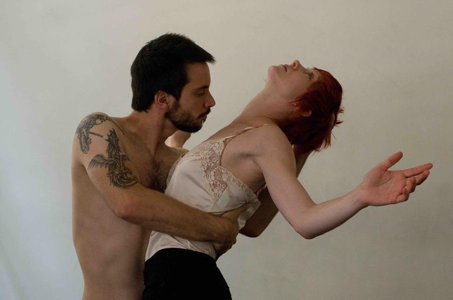 A man and a woman holding each other while dancing. 