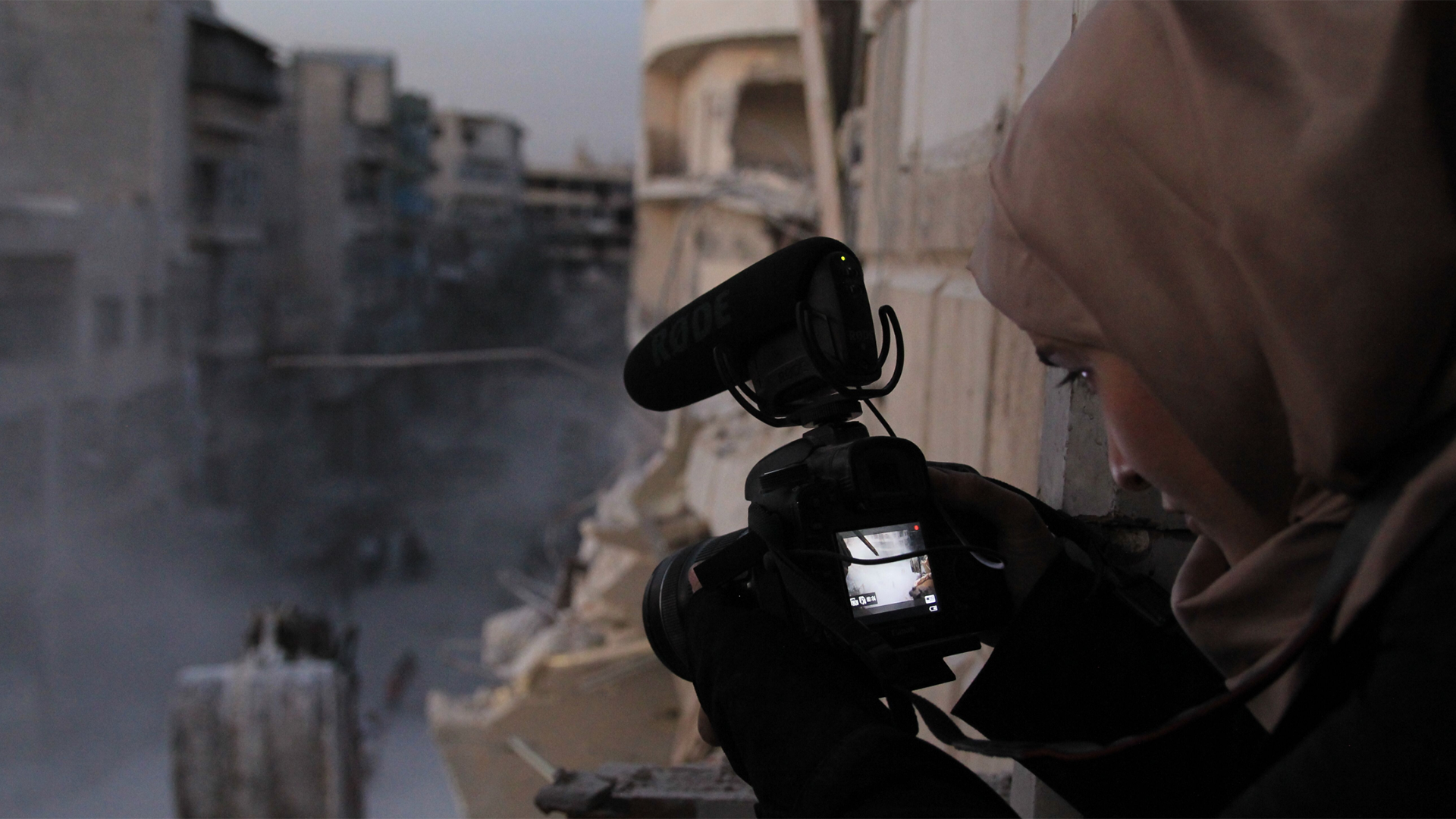Waad al-Kateab filming the ruins of a building destroyed by bombing in besieged east Aleppo
