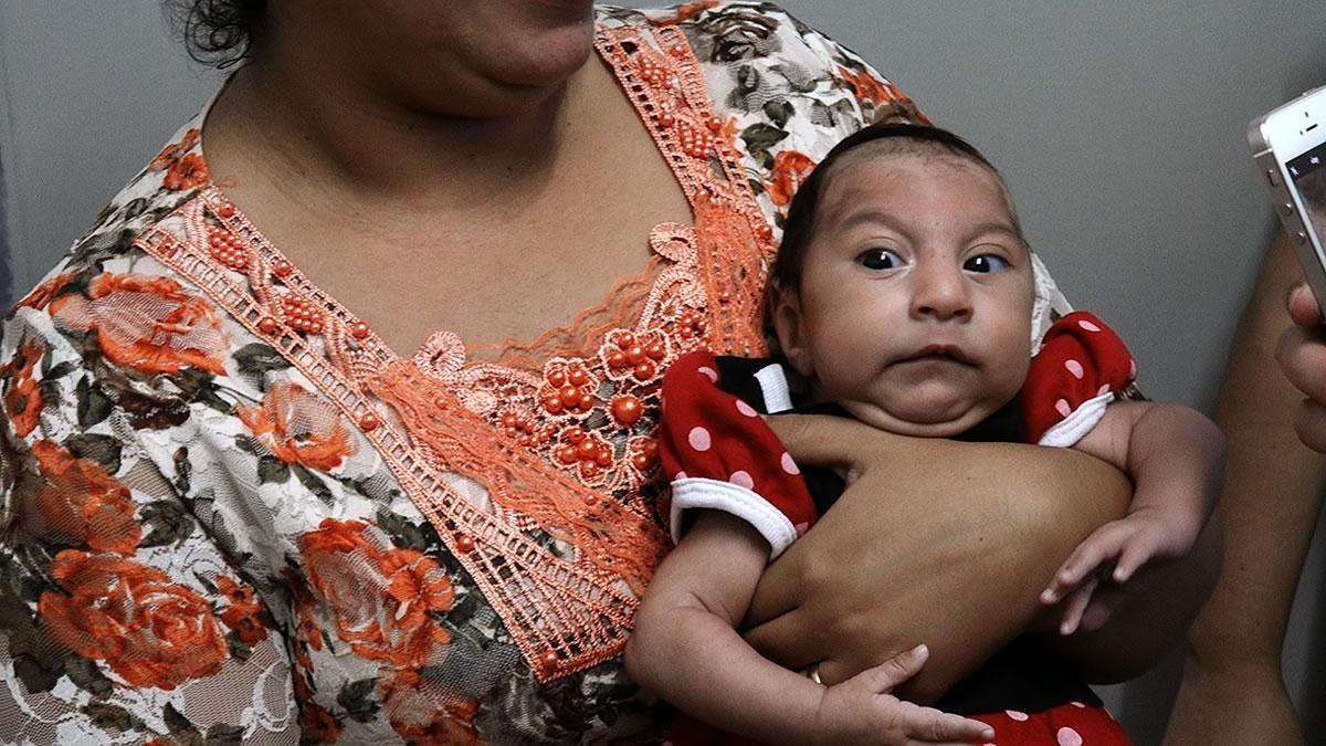close-up of a woman holding a baby