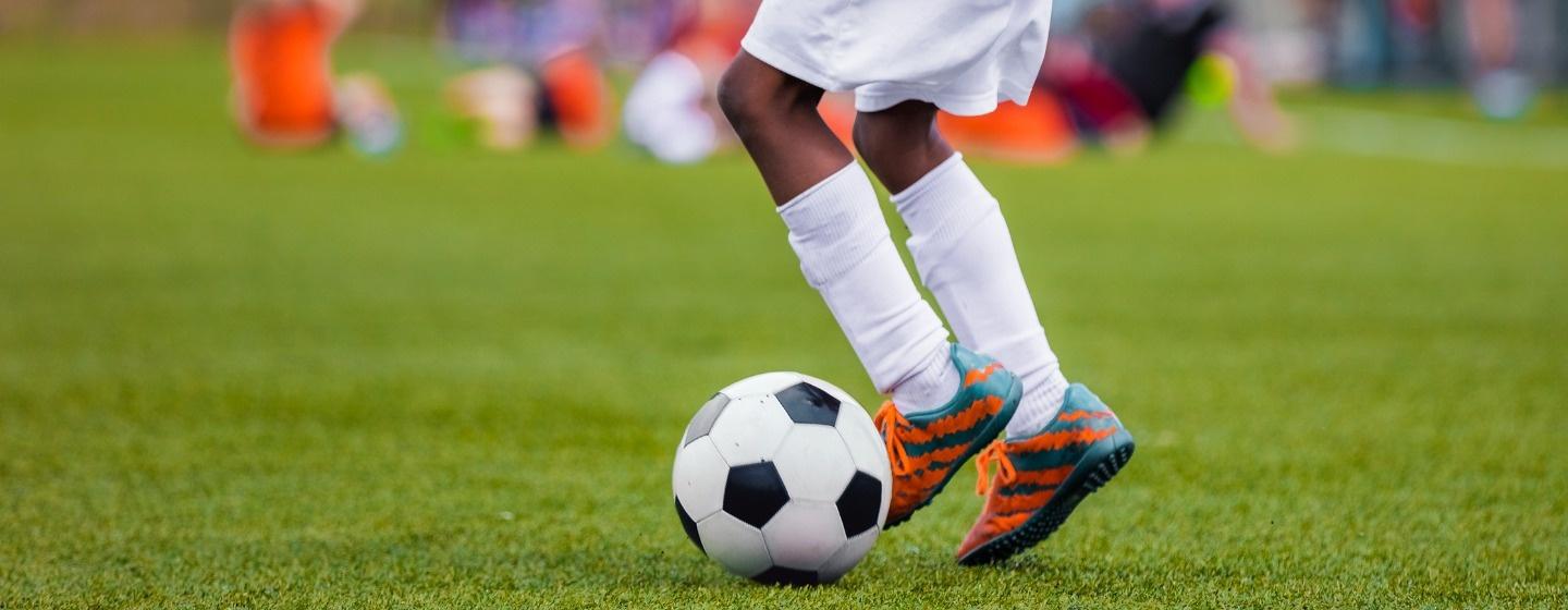 Child kicking a soccer ball