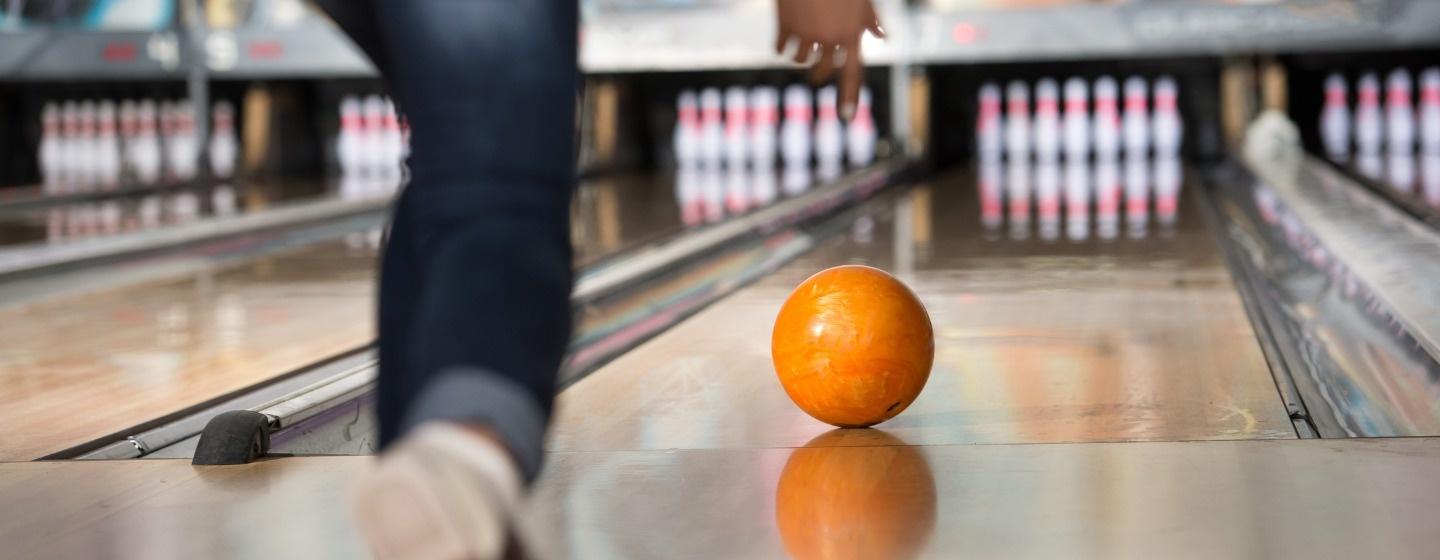 Woman throws a bowling ball