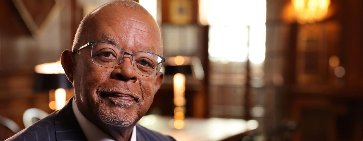 Henry Louis Gates, Jr. is smiling at the camera.