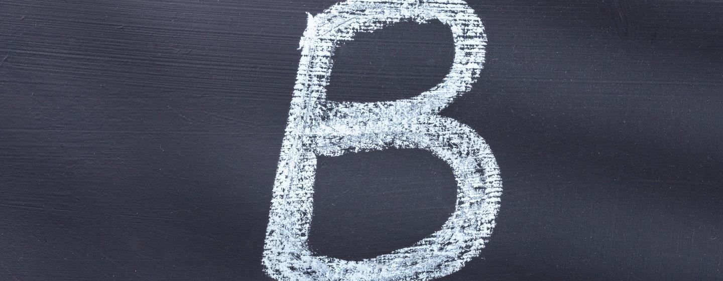 Capitalized letter B on a chalkboard