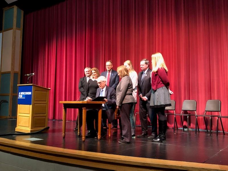 Governor Tony Evers signs peer-to-peer bill into law.