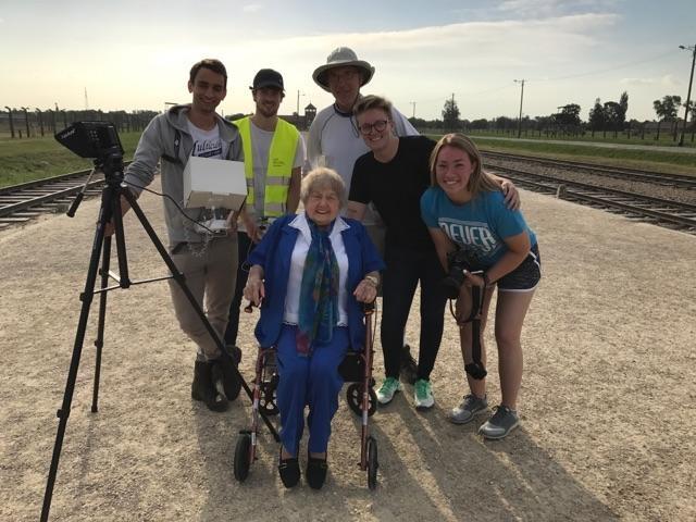The documentary film crew with Eva Kor near the railroad tracks that brought Jewish men, women and children to Auschwitz.