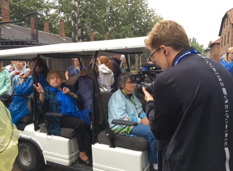 Eva Kor leads a tour group through Birkenau, Auschwitz.