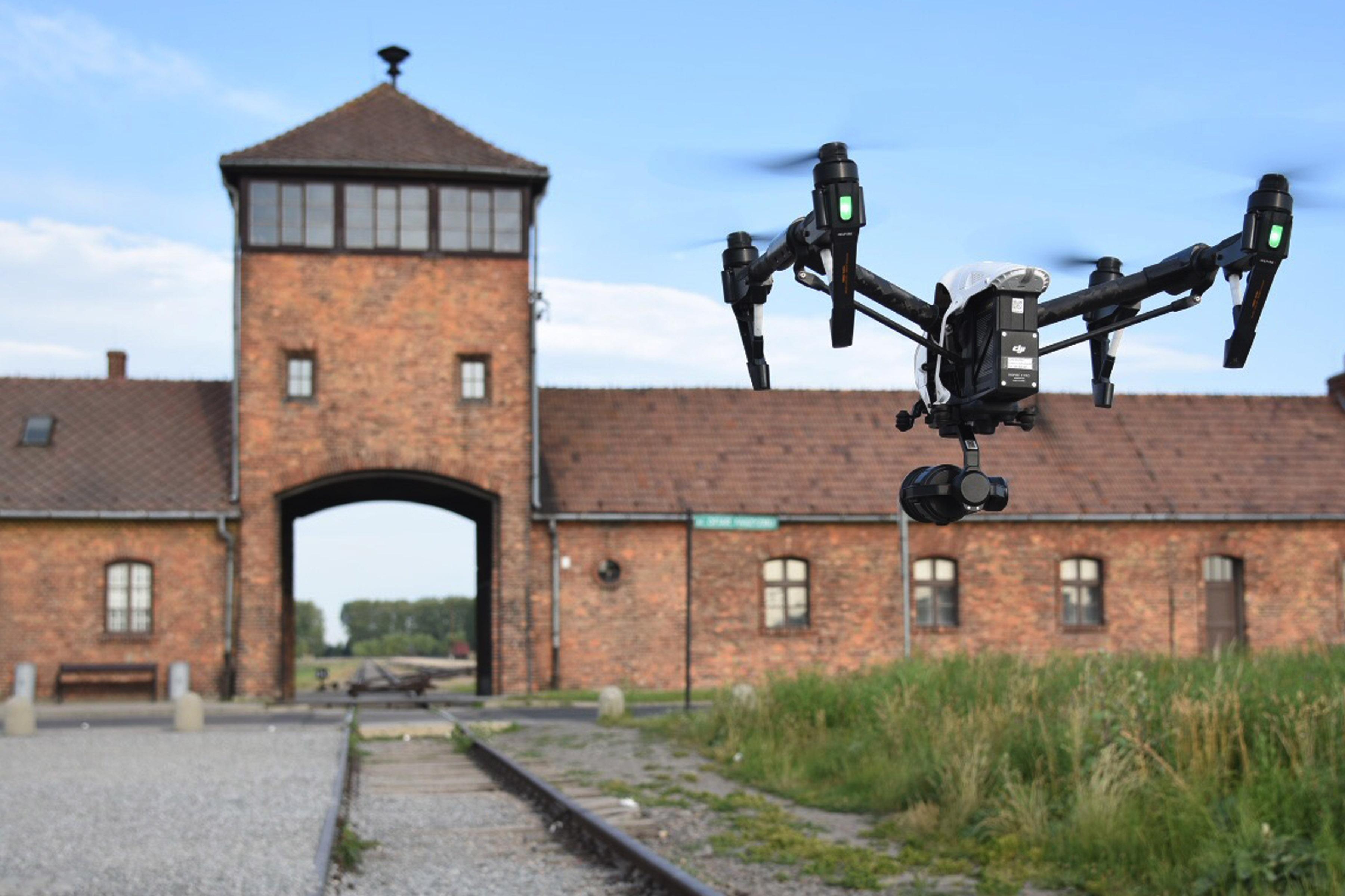 Drone flying towards the entrance of Auschwitz.