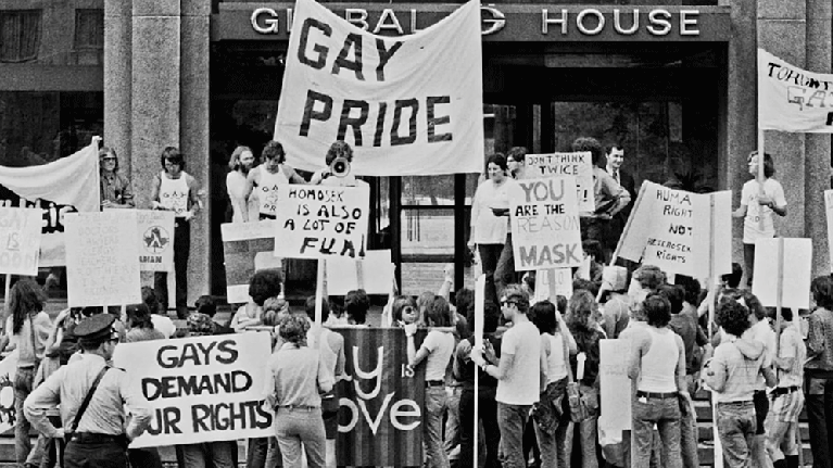 Black and white photo activists holding gay pride signs