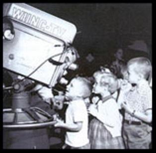 Vintage photo of kids at WUNC camera