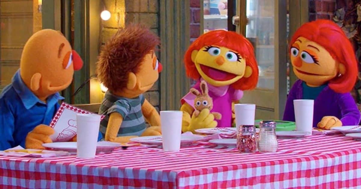 Sesame Street characters sitting at a picnic table