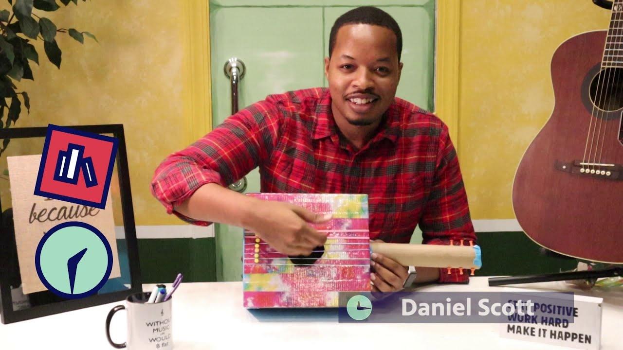 Teacher Daniel Scott displays homemade musical instrument