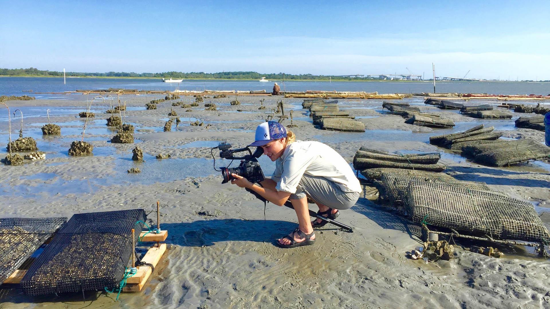 Woman shooting a video at the beach