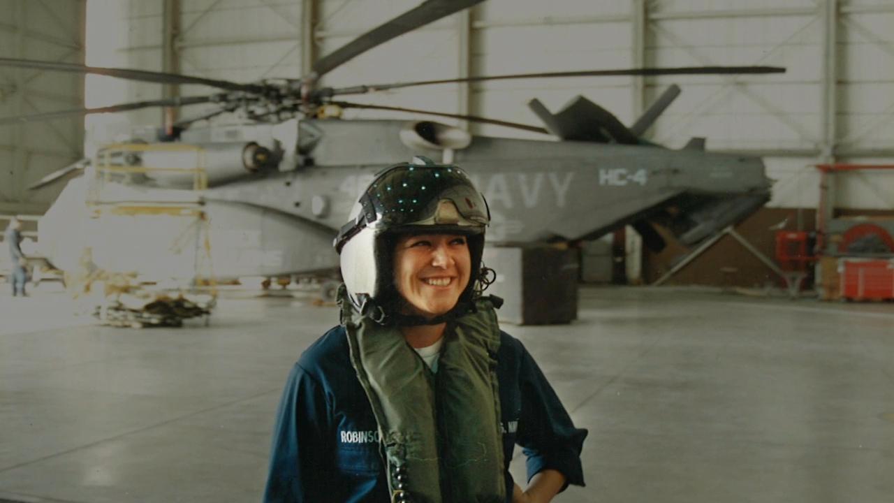 Elizabeth Perez in front of Navy helicopter