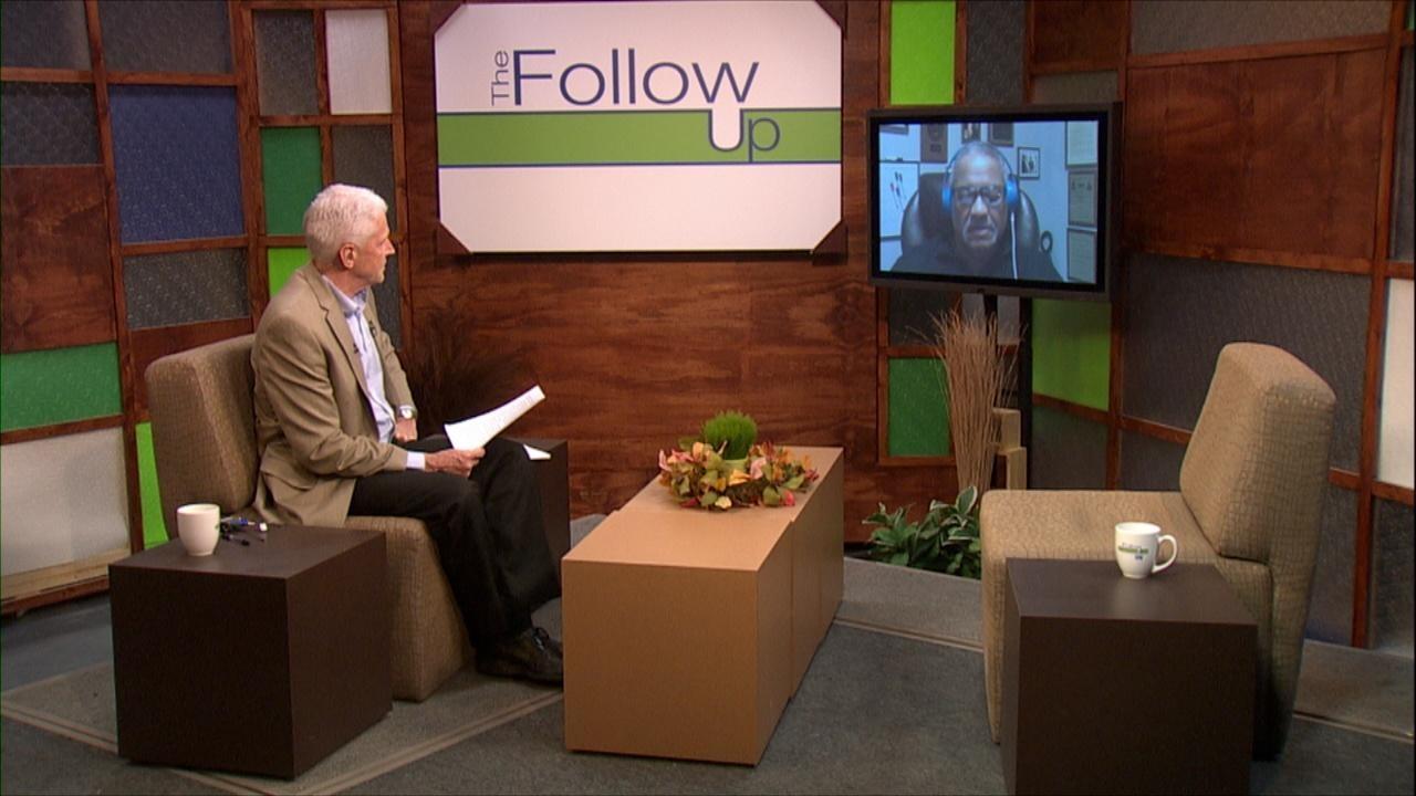 Host Mike Redford and a guest on a monitor.