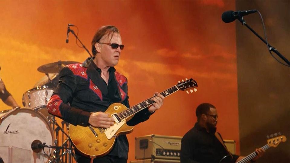 Joe Bonamassa and his band playing on stage.