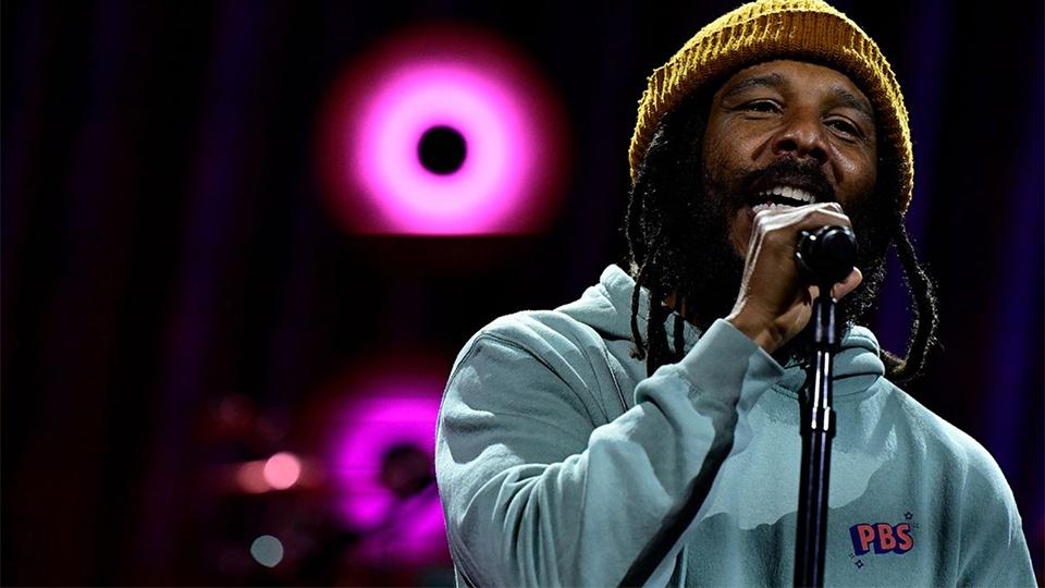 Ziggy Marley singing in a PBS hoodie.