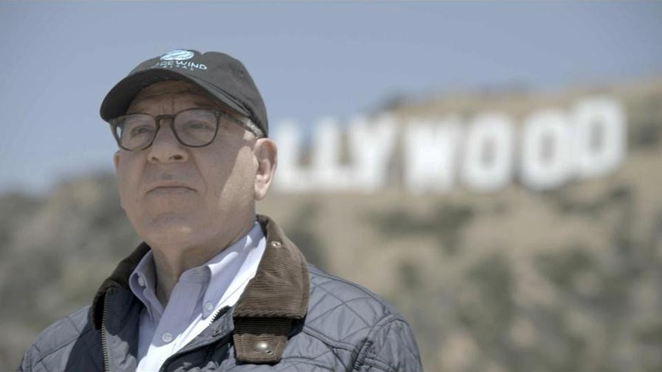David Rubenstein stands in front of the Hollywood sign.