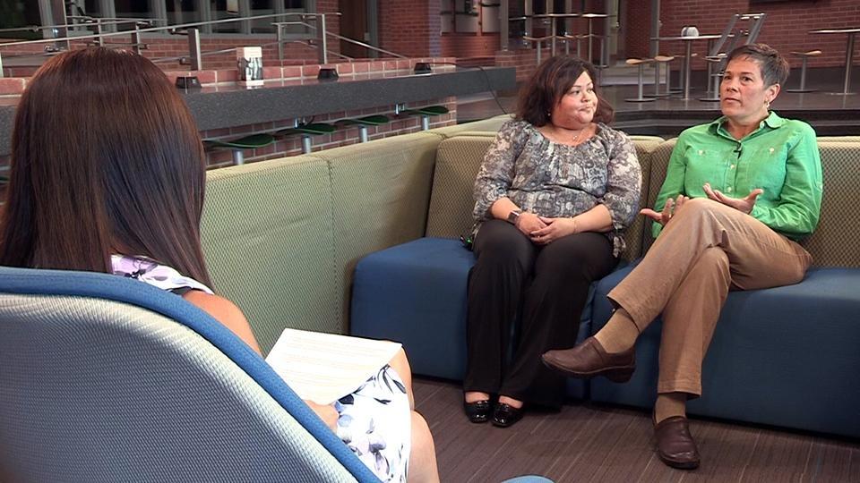 Host Nina Hageness interviews Delta College faculty members on a couch.