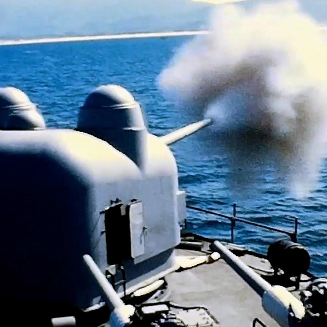 The USS Edson fires its guns.