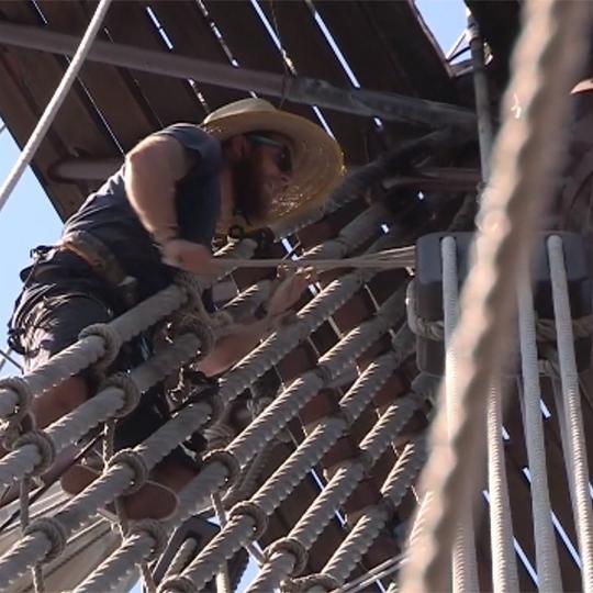An El Galeon crew member climbs the ropes.