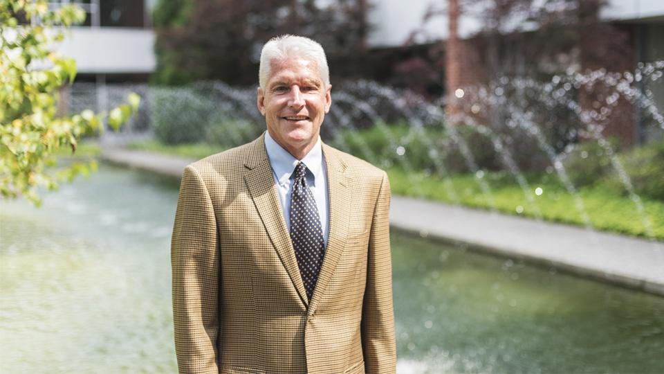 Host Mike Redford in front of the Delta College fountain.
