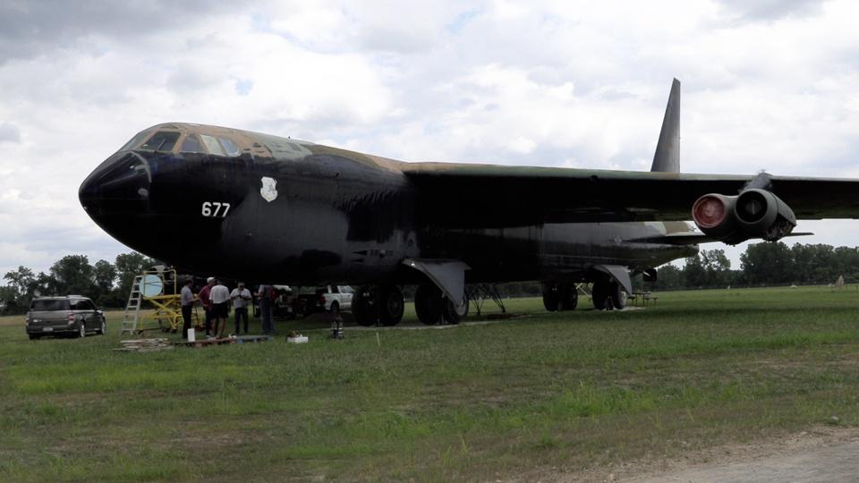 A decommissioned B-52 bomber on a field.