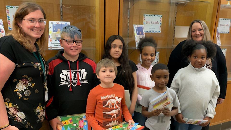 Lauren Saj with students at a book dropoff.