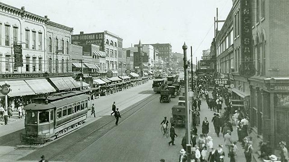 People and streetcars on the street in downtown Flint in the early 20th century.