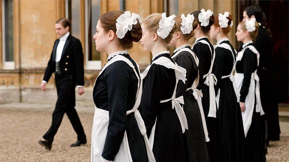 Household servants line up outside of Downton Abbey in a scene from 'Downton Abbey' on 'Masterpiece'.
