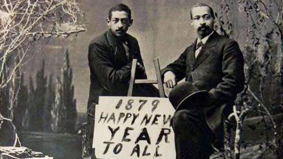 The Gooridge Brothers with a sign that says, '1879 - Happy New Year to all.'