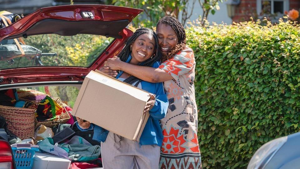 Suzie hugging Zeta as she packs a car.