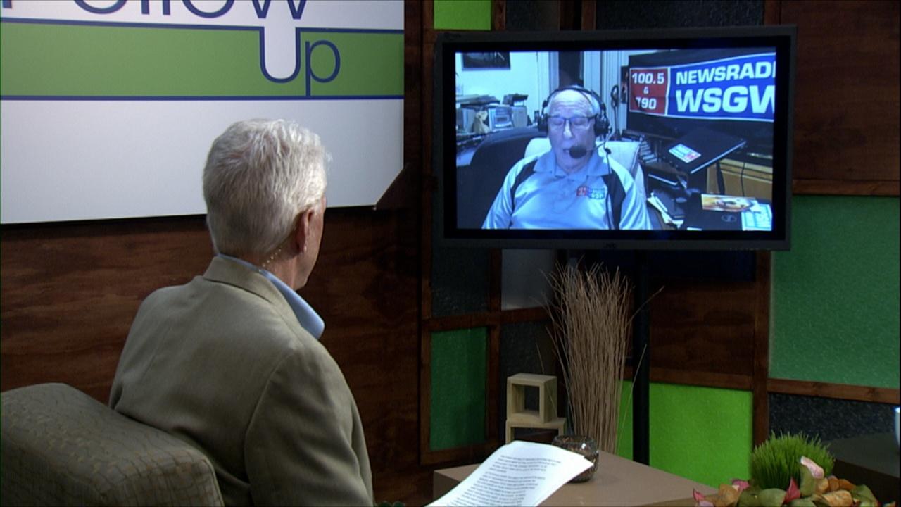 Mike Redford in the studio with Art Lewis on a monitor.