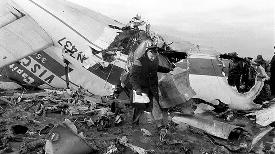 A police officer investigates the wreckage of Capital Airlines flight 67.