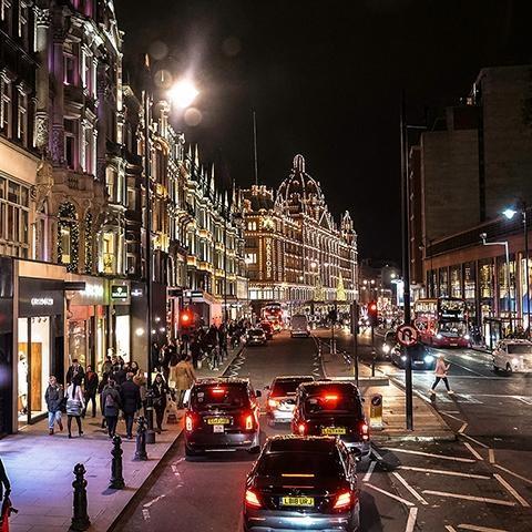 Lights on a London street at night.