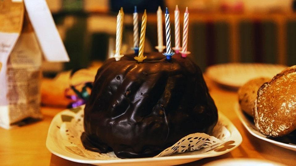 A chocolate birthday cake with candles.