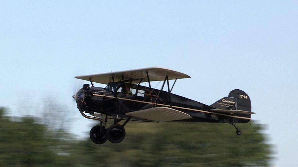 A propeller-driven Cabinaire airplane in flight.
