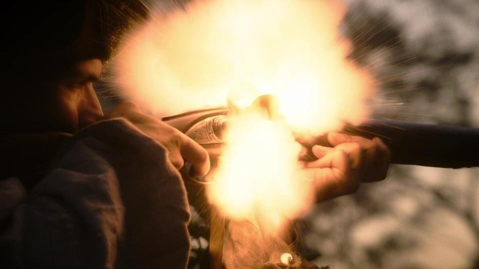 A reenactment of a soldier firing a musket in the Revolutionary War.