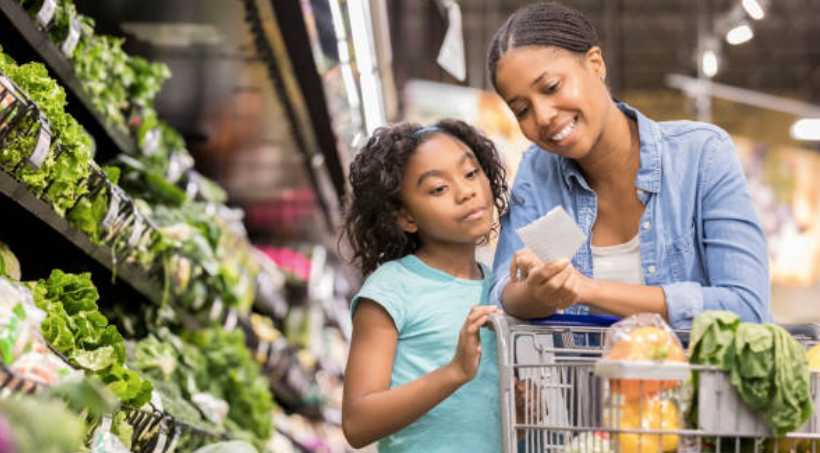 adult and child reading grocery list in produce section
