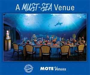 A large dining table, set inside a large aquarium. Promoting MOTE Venues