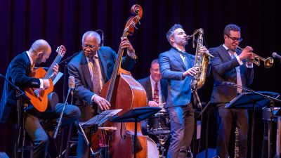 Musicians playing together on a stage