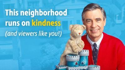 Mr Rogers holding a plush, stuffed toy