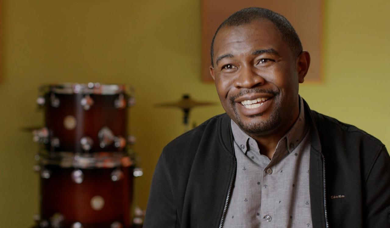 Up close shot of Etienne Porter with drums behind him