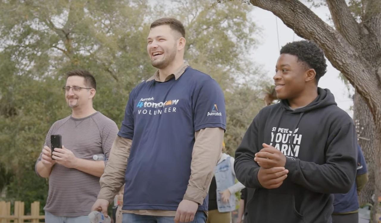 Three male volunteers smiling at St Pete Youth Farm