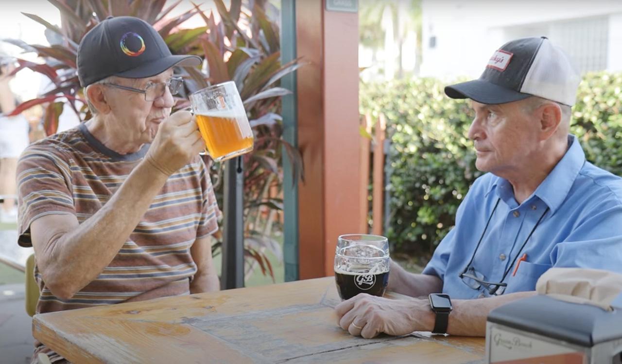 Two older gentlemen enjoying a beer together