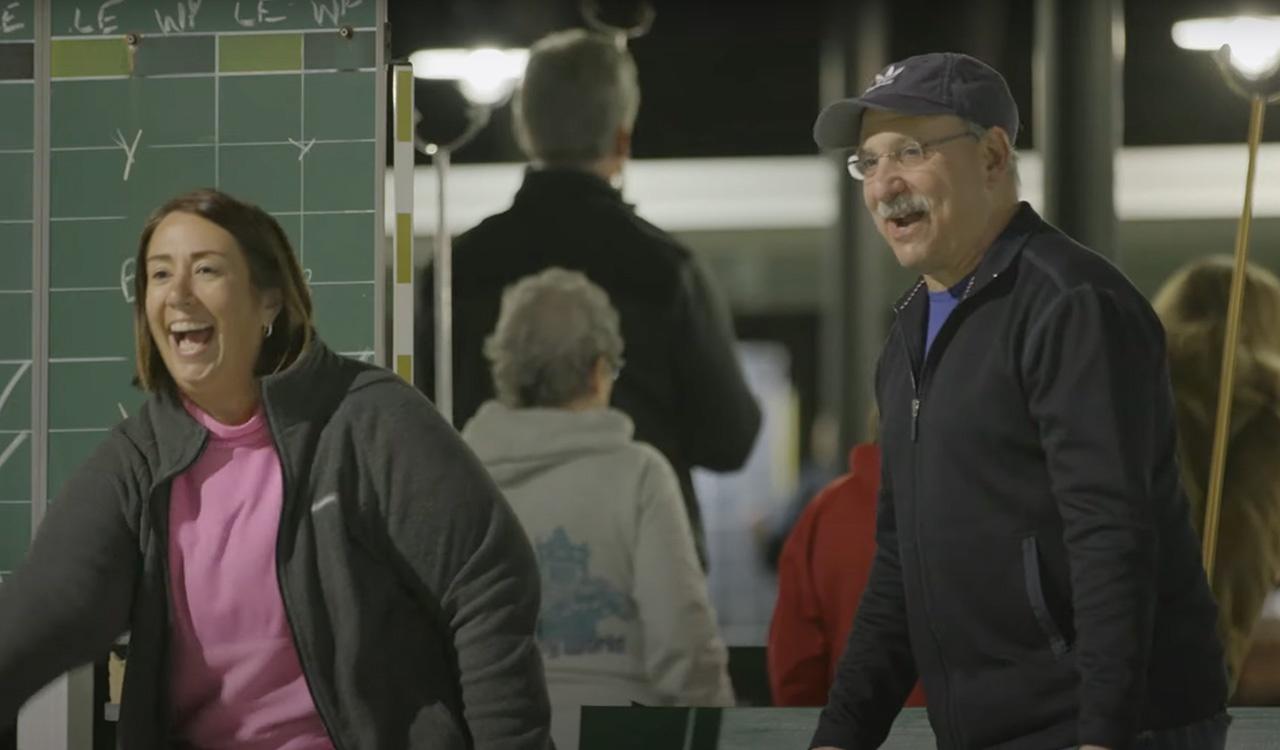 Man and woman playing shuffleboard