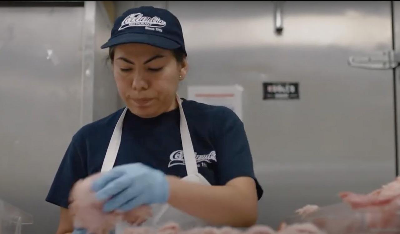 Worker at La Segunda preparing sandwiches